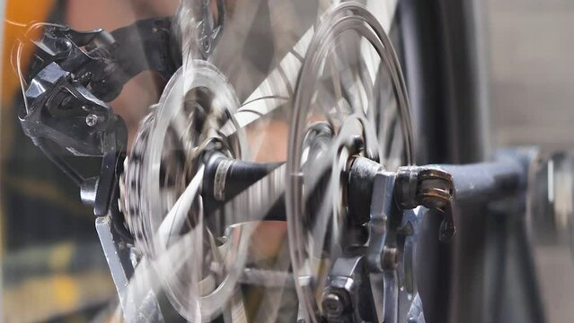 Close-up of a wheel and brake disc spinning in a bicycle workshop. Bicycle workshop