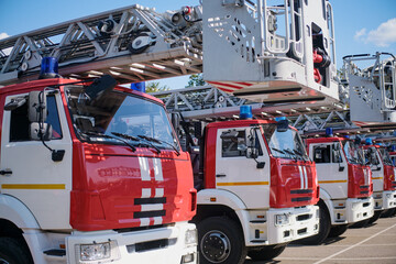 Fire trucks lined up at a fire station waiting to be used.