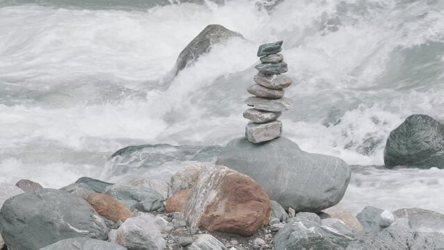 Harmony, balance and simplicity concept. Creative. A stone pyramid on the background of river water.