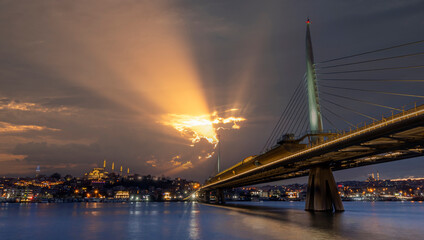 New Halic Metro Bridge at summer night blue sky and city lights in Istanbul, Turkey