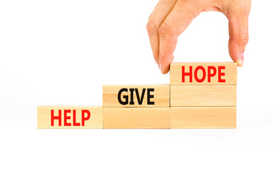 Help give hope symbol. Concept word Help give hope on beautiful wooden block. Businessman hand. Beautiful white table white background. Business motivational help give hope concept. Copy space.