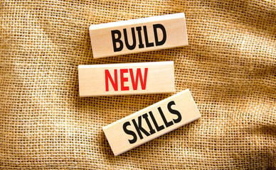 Build new skills symbol. Concept word Build new skills on beautiful wooden block. Beautiful canvas table canvas background. Business, education build new skills concept. Copy space.