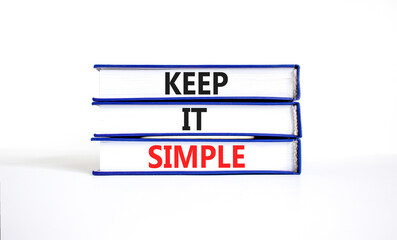 Keep it simple symbol. Concept word Keep it simple on beautiful books. Beautiful white table white background. Business motivational keep it simple concept. Copy space.