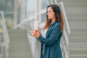 business woman in the street with tablet or ebook