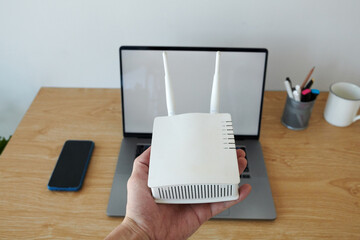 Hand of developer showing wifi router