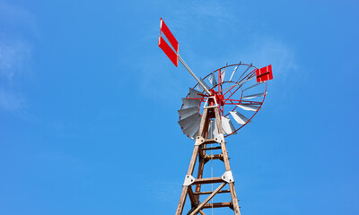 An old windpump against the blue sky.