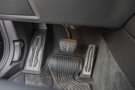 Close-up view of pedals in foot area of vehicle with automatic transmission.