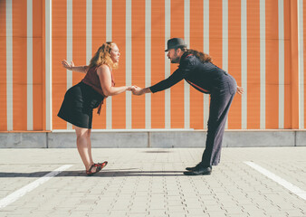 Cheerful couple dancing a retro swing dance to jazz music which was very popular during West Coast...