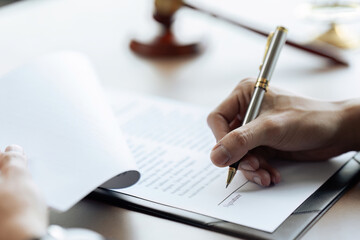 Lawyers or judges sign documents in accordance with legal and fair terms of agreement
