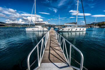 Two white boats standing on the pier in sunny day