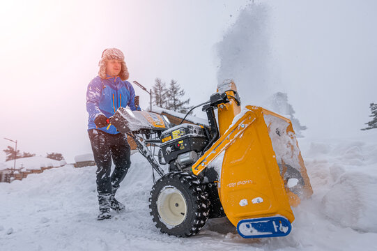 Snow Removal Equipment. Clearing snow from access road using a snow blower.