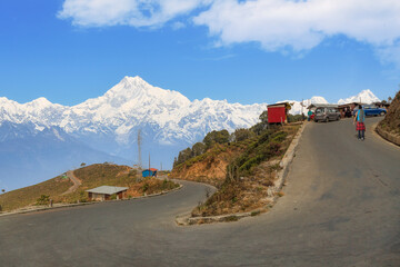 Scenic high altitude mountain road with view of the majestic Kanchenjunga Himalaya range near Tinchuley in Darjeeling district of India