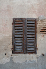 Old window with shutters. Ancient building