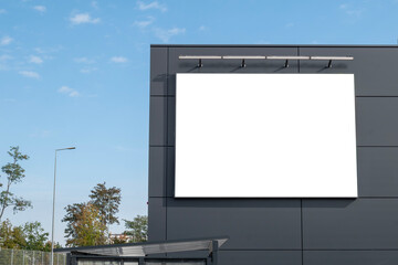 Blank white advertising banner on the wall of the modern building