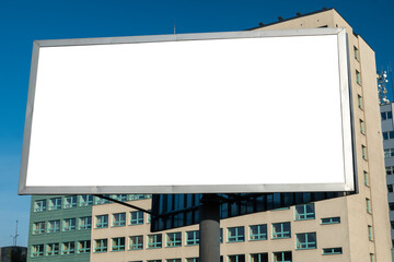 Blank white advertising billboard in front of the modern office building
