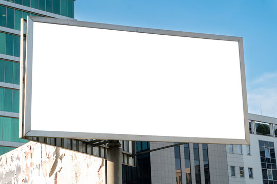 Blank white advertising billboard in front of the modern office building