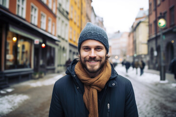 Portrait of a young smiling man standing on the city street in Stockholm