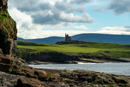 Classiebawn castle in front of Benbulben Mountain, seen from Mullaghmore Head, County Sligo, Ireland