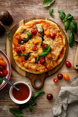 Pizza Margherita on a wooden background