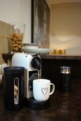 coffee flows into a mug from a coffee machine with capsules