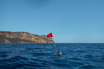 A red buoy while kayaking to the Calanques fjords on the Mediterranean sea near Cassis in summer