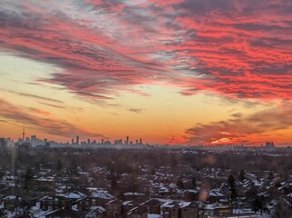 sunset seen in the sky of Toronto, with the blanket of snow, and red velvet sky