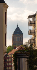 Old water tower in the distance with foreground buildings and trees