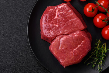 Raw fillet steak mignon beef with salt, spices and herbs