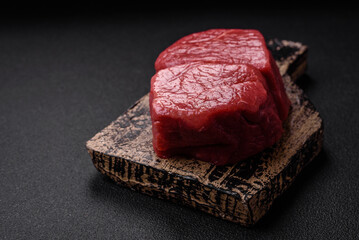Raw fillet steak mignon beef with salt, spices and herbs