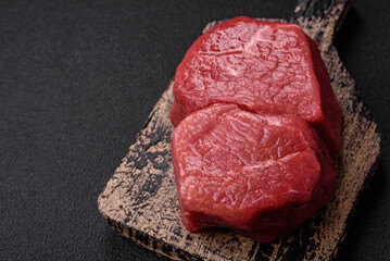 Raw fillet steak mignon beef with salt, spices and herbs