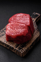 Raw fillet steak mignon beef with salt, spices and herbs