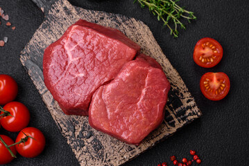 Raw fillet steak mignon beef with salt, spices and herbs