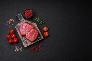 Raw fillet steak mignon beef with salt, spices and herbs