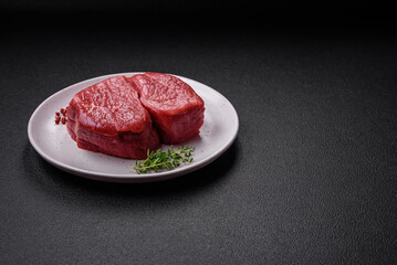 Raw fillet steak mignon beef with salt, spices and herbs