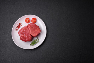 Raw fillet steak mignon beef with salt, spices and herbs