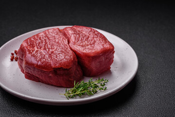 Raw fillet steak mignon beef with salt, spices and herbs