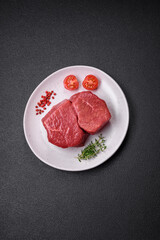 Raw fillet steak mignon beef with salt, spices and herbs