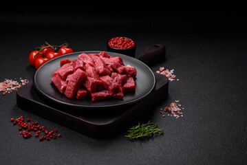 Raw organic meat beef or lamb cut into slices with salt, spices and herbs
