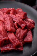 Raw organic meat beef or lamb cut into slices with salt, spices and herbs