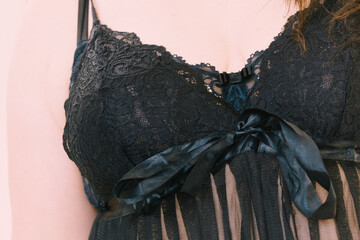 Woman in black lingerie showing her breast chest.