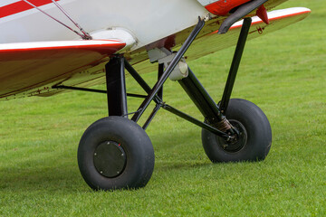 Chassis of a light sports aircraft on a grass field close-up