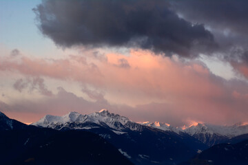 Fototapeta na wymiar Picturesque sunset over picturesque winter mountains with clouds