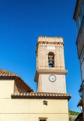 Bell tower against blue sky in Bolulla town, Alicante (Spain)