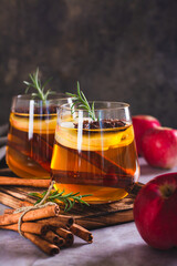 Apple margarita with spices and rosemary in glasses on the table vertical view