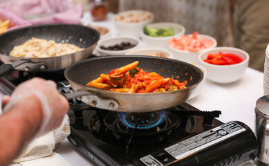 Sizzling culinary artistry in a hot frypan, epitomizing the joy and creativity of home cooking
