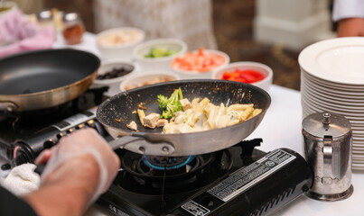 Sizzling culinary artistry in a hot frypan, epitomizing the joy and creativity of home cooking