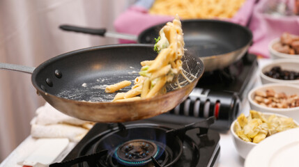 Sizzling culinary artistry in a hot frypan, epitomizing the joy and creativity of home cooking