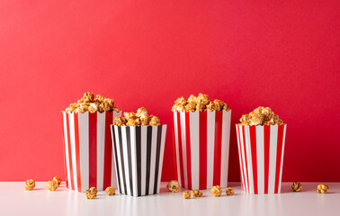 Film premiere with the crew! A side view photo of white table featuring striped popcorn boxes...