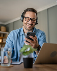 One man caucasian male freelancer work from home use mobile phone talk