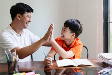 Father and son give high five celebrate success..